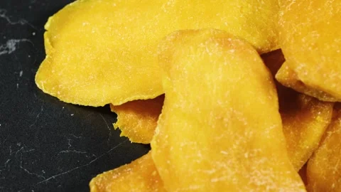 Heap of dried mango slices on dark background. Stock Footage 295037346