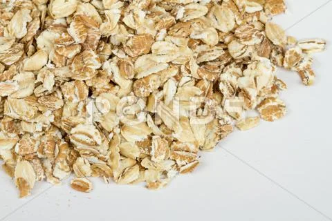 Heap of dry rolled oats isolated on white background Stock Photos