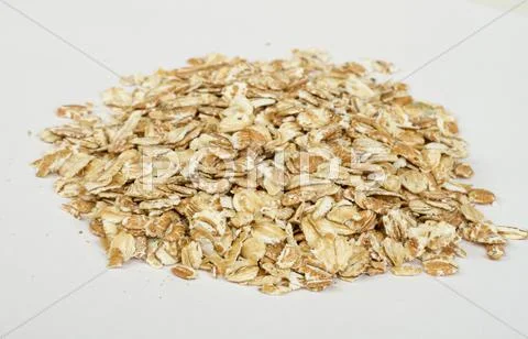 Heap of dry rolled oats isolated on white background Stock Photos