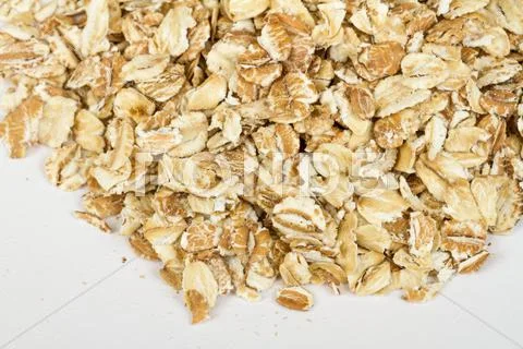 Heap of dry rolled oats isolated on white background Stock Photos