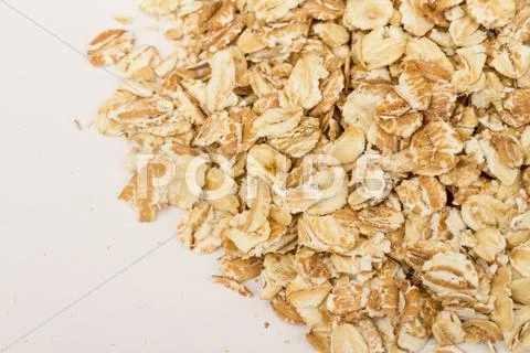 Heap of dry rolled oats isolated on white background Stock Photos