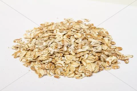 Heap of dry rolled oats isolated on white background Stock Photos