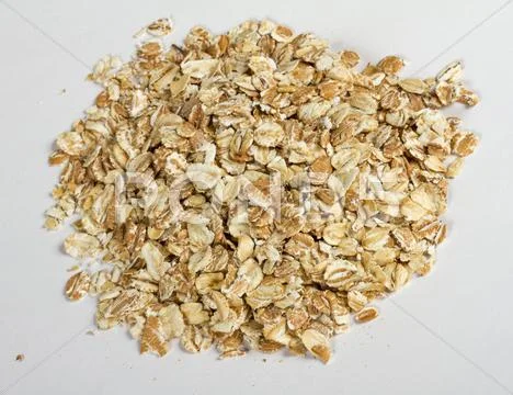 Heap of dry rolled oats isolated on white background Stock Photos