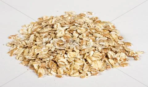 Heap of dry rolled oats isolated on white background Stock Photos