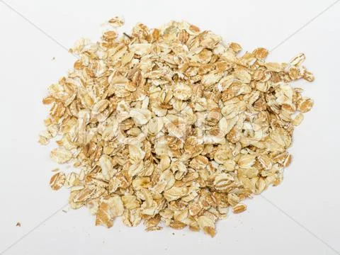 Heap of dry rolled oats isolated on white background Stock Photos