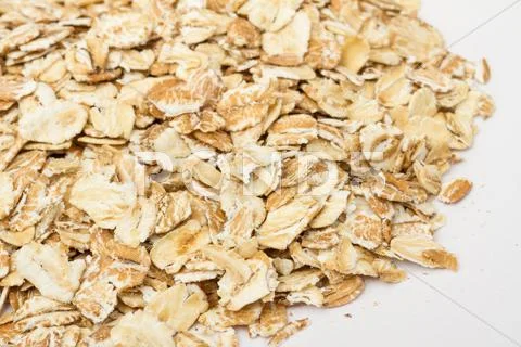 Heap of dry rolled oats isolated on white background Stock Photos