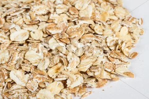 Heap of dry rolled oats isolated on white background Stock Photos