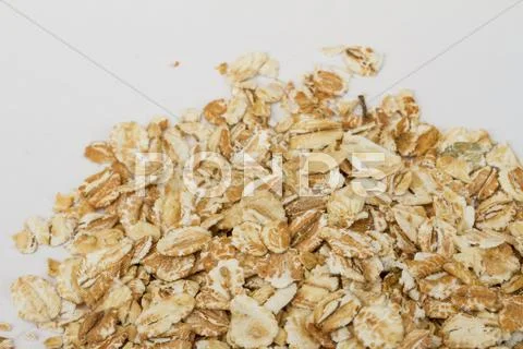 Heap of dry rolled oats isolated on white background Stock Photos