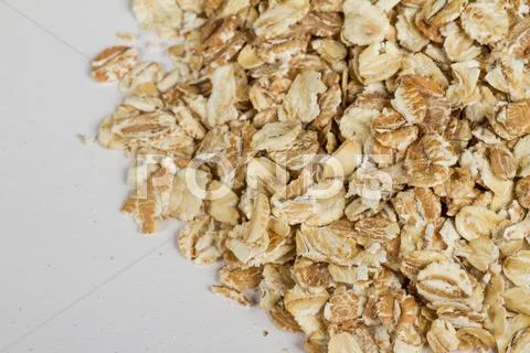 Heap of dry rolled oats isolated on white background Stock Photos
