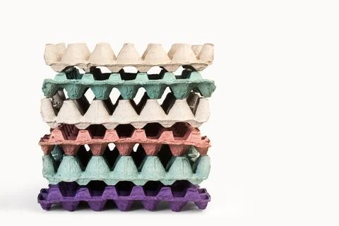 A heap of empty colored cardboard egg tray on a white background Stock Photos