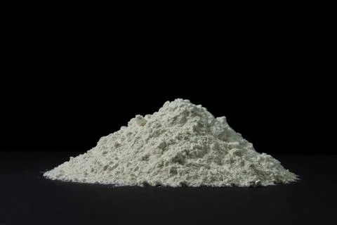 Heap of flour on a black background.  Stock Photos