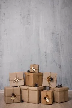 Heap of gift boxes and copy space over grey concrete wall 库存照片