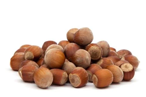 Heap hazelnuts on a white background Stock Photos