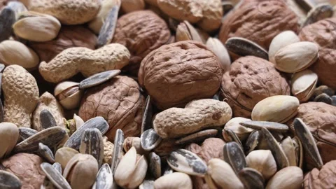 Heap of mixed nuts rotating: walnut, peanut, pistachio and sunflower seed Stock Footage 159953028