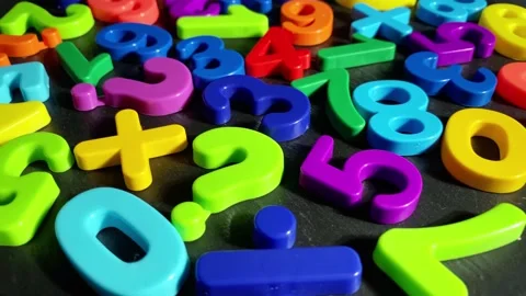 Heap of multicolored numbers on black stone background. Stock Footage 219913087