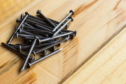 Heap of nails on the wooden table Stock Photos