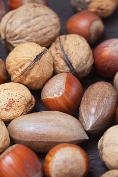 Heap of nuts on a wooden surface Stock Photos