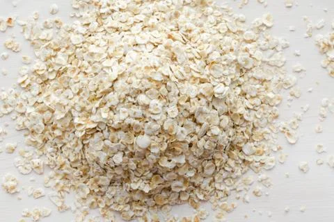 Heap of oat flakes on a white background Stock Photos