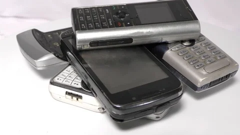 Heap of old mobiles doing rounds on white surface Stock Footage 111887872
