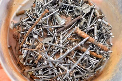 Heap of old rusty nails and screws on bottom of can Stock Photos