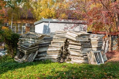 Heap of old wooden window frames with glass outdoors. Broken materials after  Foto stock