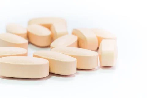 Heap of orange round medicine tablet pills Stock Photos