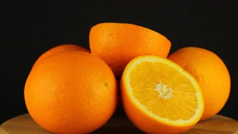 The heap oranges rotates on a black background. Close-up video vitamin. 스톡 동영상 151538816