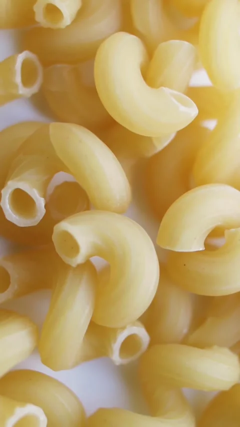 Heap of organic solid pasta on a rotating table. Vertical video. Stock Footage 269306903