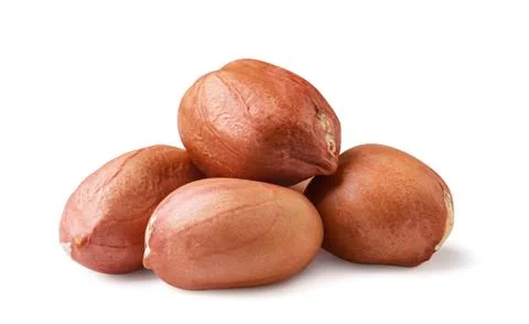 Heap of peanuts without shell close-up on a white background. Stock Photos