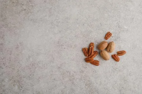 Heap of pecan nuts on marble table Stock Photos