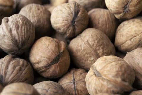 Heap of raw walnuts close-up as background. Stock-Fotos