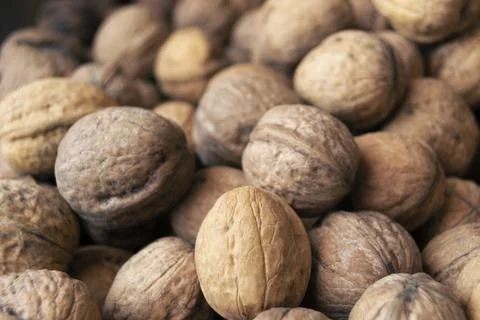 Heap of raw walnuts close-up as background. Stock-Fotos