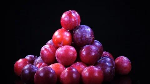 Heap of ripe fresh plums rotating in 4K against black background 스톡 동영상 86974842