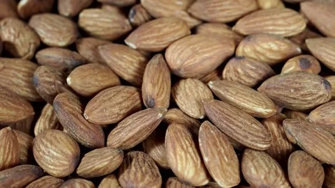 Heap of roasted almonds on a turntable, close-up Stock Footage 157988848