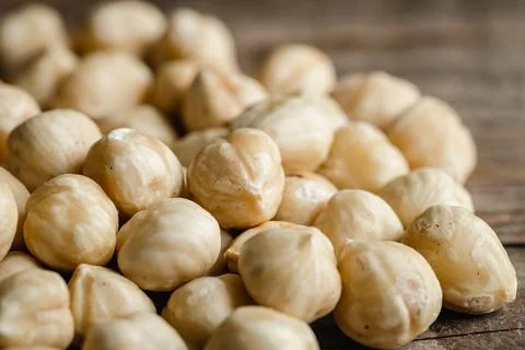 Heap of roasted hazelnuts close-up, macro shot. Stock Photos