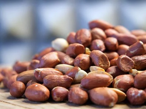 Heap of roasted peanuts, macro. Nuts. Peanuts peeled and fried. Stock Photos