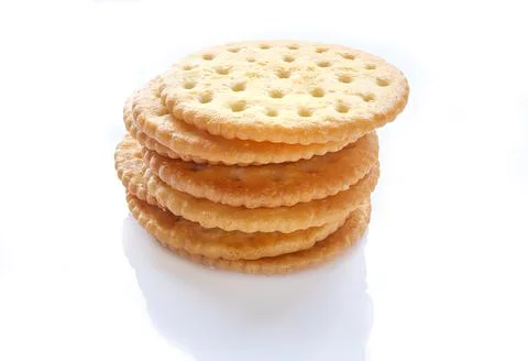 Heap of round crispy crackers on a white background. Stock Photos