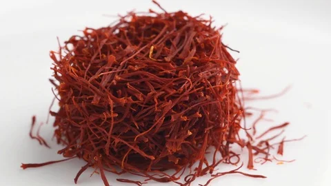 Heap saffron threads, autumn crocus, on turntable isolated on white background Stock Footage 128676155