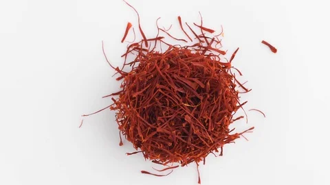 Heap of saffron threads, autumn crocus, on turntable isolated white background 動画素材 128676172