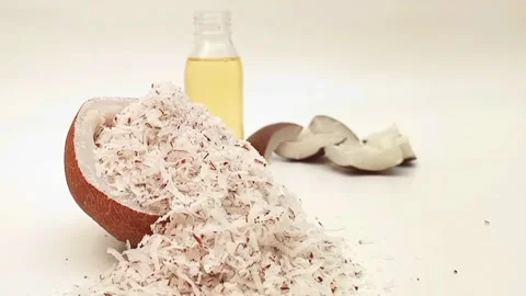 A heap of shredded coconut inside a half coconut piece focusing with coconut Stock Footage 275670165
