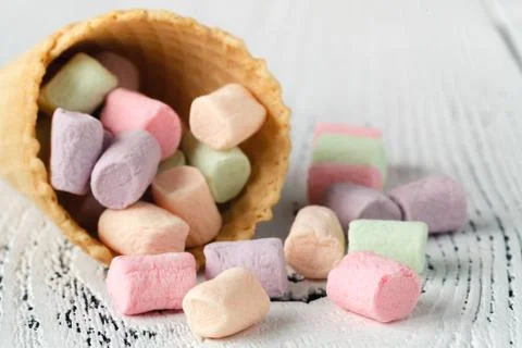 Heap of small colored marshmallow on table Stock Photos