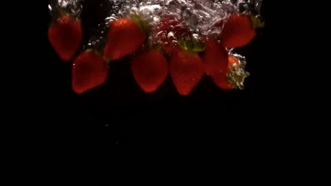 Heap of strawberries in slow motion falling into water Stock Footage 137168586