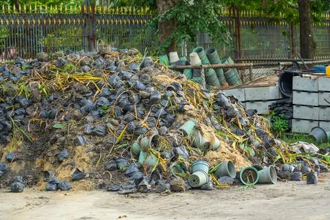 Heap of waste garbage dump with pots and leaves of dried plants in rural area 스톡 사진