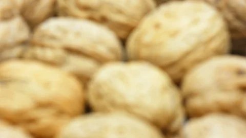 Heap whole walnuts nutshell closeup rack focus 4k footage Stock Footage 106308610