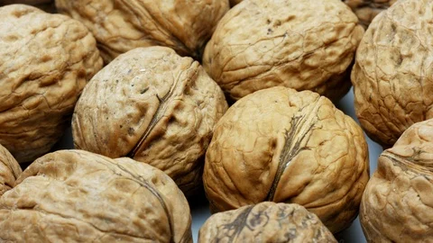 Heap whole walnuts nutshell closeup rotating 4k footage Stock Footage 106310199