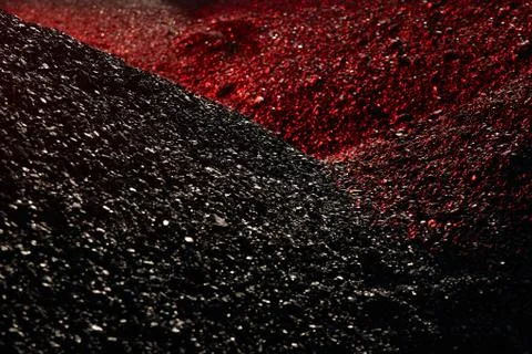 Heaps of coal in the red light Stock Photos