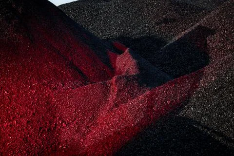 Heaps of coal in the red light Stock Photos