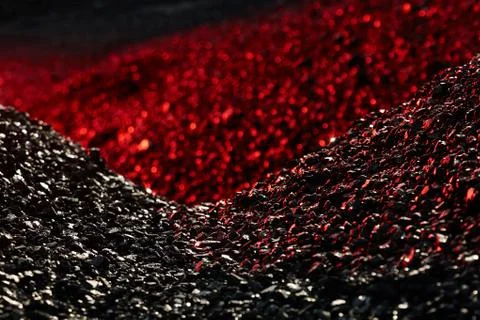 Heaps of coal in the red light Stock Photos