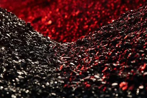 Heaps of coal in the red light Stock Photos