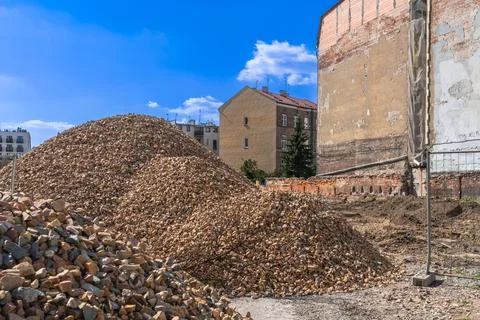 Heaps of construction pebbles at a construction site in an old European city Stock Photos